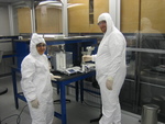 Mike Dickson and Yogeshwari Patel are mixing chemicals at a workstation in the cleanroom