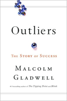 Cover of Outliers showing marbles--I think--with a single larger marble set apart from the rest.