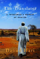 A dark-skinned man wearing long white robes and matching headcover walks away into the African landscape.
