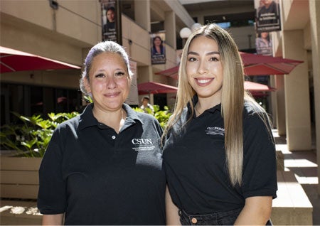 Cynthia Montes (left) and Areli Araujoean(right) wearing black polo shirts