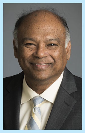 CSUN Dean Chandra Subramaniam in a suite with a cream shirt and grey and cream tie