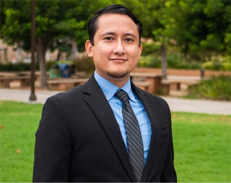 German Cruz Ruiz in a suite with blue shirt and grey tie