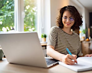 Student takes notes from a laptop computer