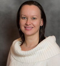 Female Professor Svetlana Tyutina in a white casual shirt