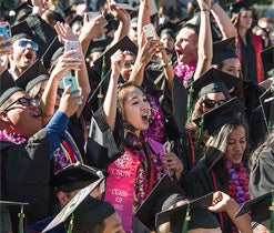 Students cheering at 2016 graduation.