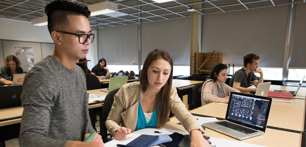 A male and female student collaborate.