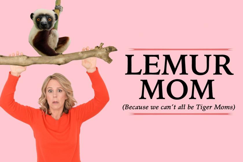 A woman holding up a branch with a lemur on it