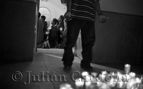 Young men and boys from southern Mexico light votive candles and pray for a safe crossing before leaving the Sonoran town of Altar. Soon they will be loaded into vans and trucks and ferried North toward La Línea.