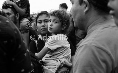 Chelita clings to her mother amidst the chaos of migrants waiting to be admitted into Mexico. After days of waiting, some families were allowed to enter in small groups, but Mexican officials didn’t say what where these families would be taken. Jan. 2020.