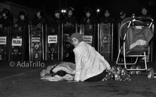 A mother and her child rest after traveling over 2,700 miles from Honduras. Attempting to present themselves as asylum seekers to the U.S. immigration authorities, they were blocked by Mexican police just 500 feet from the border.