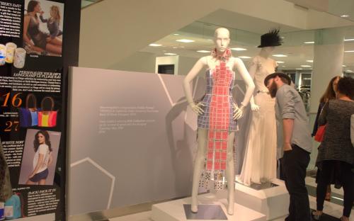 Pynes Fashion Collection, man takes a closer look at a dress made of cards.