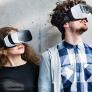 A man and a woman wearing VR headsets. 