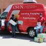 csun van with 3 people holding diapers
