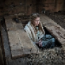 Woman crouching in root cellar
