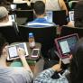 A photo showing students taking notes with their iPads during a class lecture.
