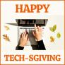 Happy Techsgiving with hands using laptop surrounded by fall leaves