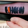 A smartphone reading a sound wave tattoo. 