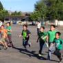 schoolchildren running across the yard