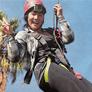 woman on ropes course smiling to camera