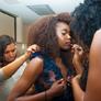 model gets dress and makeup ready for the runway at the 2017 CSUN TRENDS fashion show