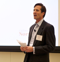 Photo of Earl Enzer talking to the audience.