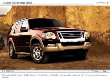 Photo of a Ford Explorer climbing a steep hill with a lake in the background.