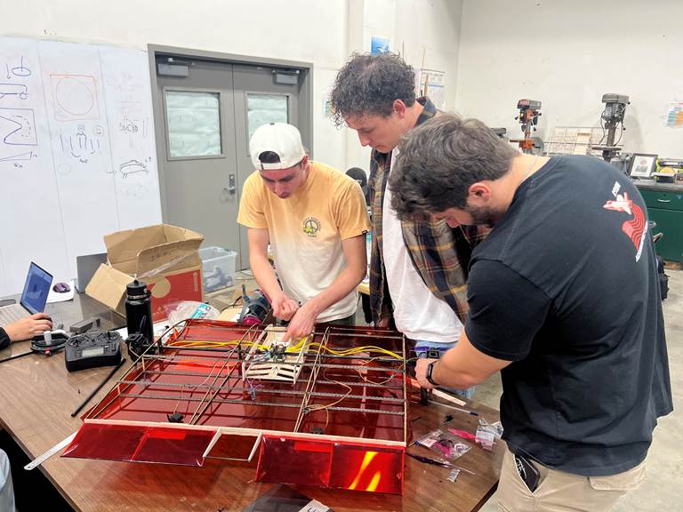 A group of men working on a project
AI-generated content may be incorrect.